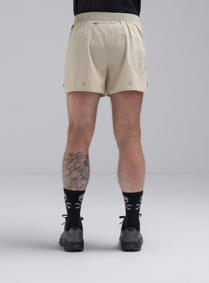 Chez Is 6ft And Wears Size: M | Hem Studio Image Of Model Wearing Force Trail Running 4” Shorts In Stone (SS Model)
