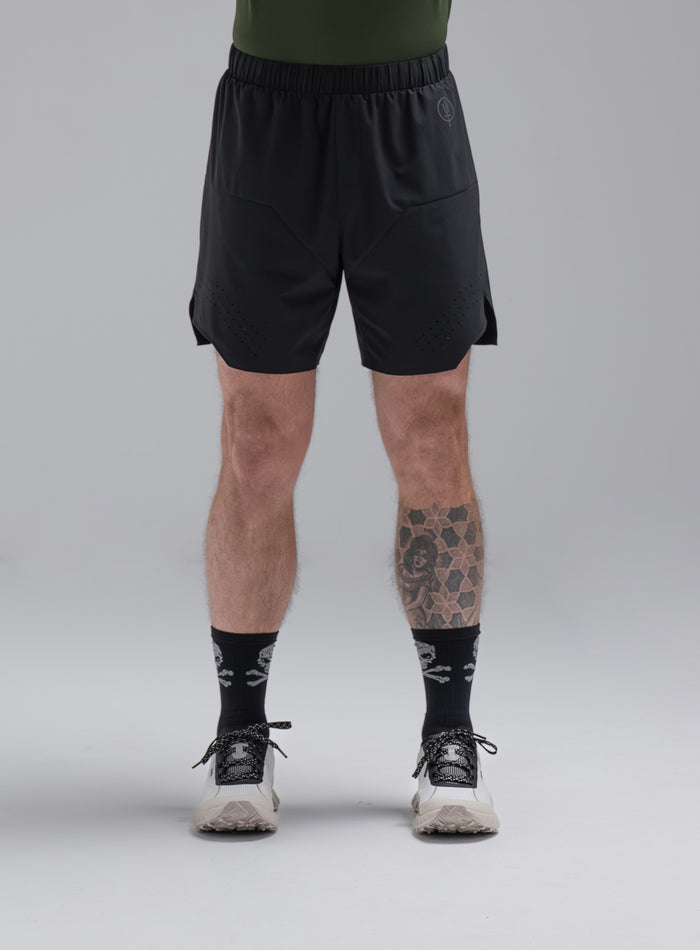 Chez Is 6ft And Wears Size: M | Hem Studio Image Of Model Wearing Force Trail Running 7" Shorts In Obsidian Black (SS Model)