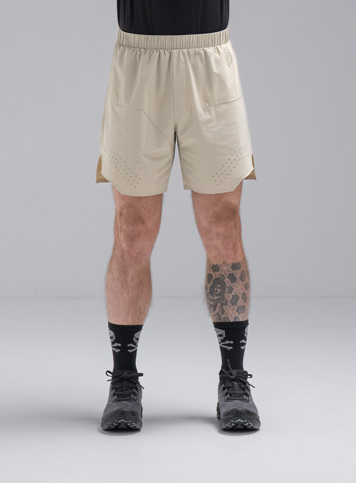 Chez Is 6ft And Wears Size: M | Hem Studio Image Of Model Wearing Force Trail Running 7" Shorts In Stone (SS Model)