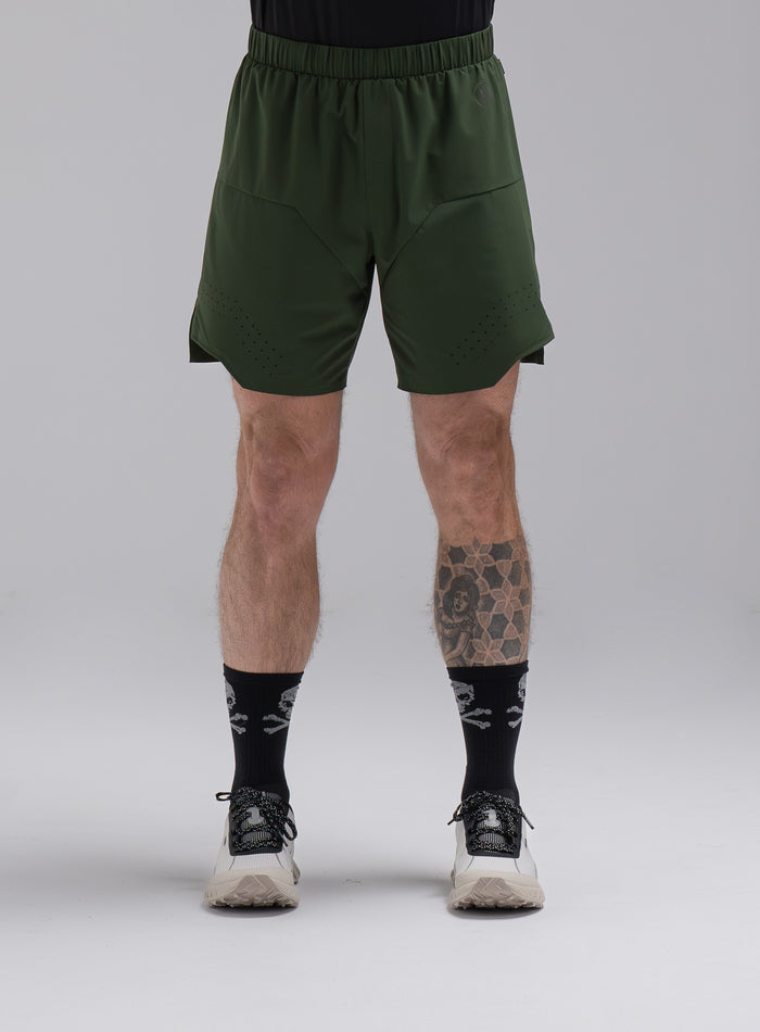 Chez Is 6ft And Wears Size: M | Hem Studio Image Of Model Wearing Force Trail Running 7" Shorts In Forest Green (SS Model)