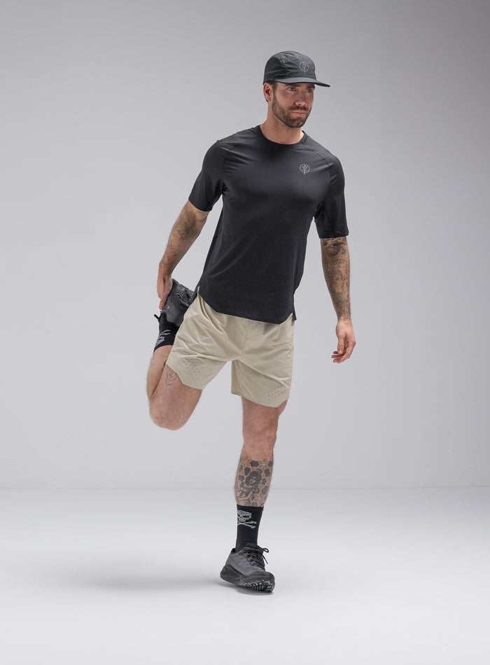 Chez Is 6ft And Wears Size: M | Hem Studio Image Of Model Wearing Force Trail Running 7" Shorts In Stone (SS Model)
