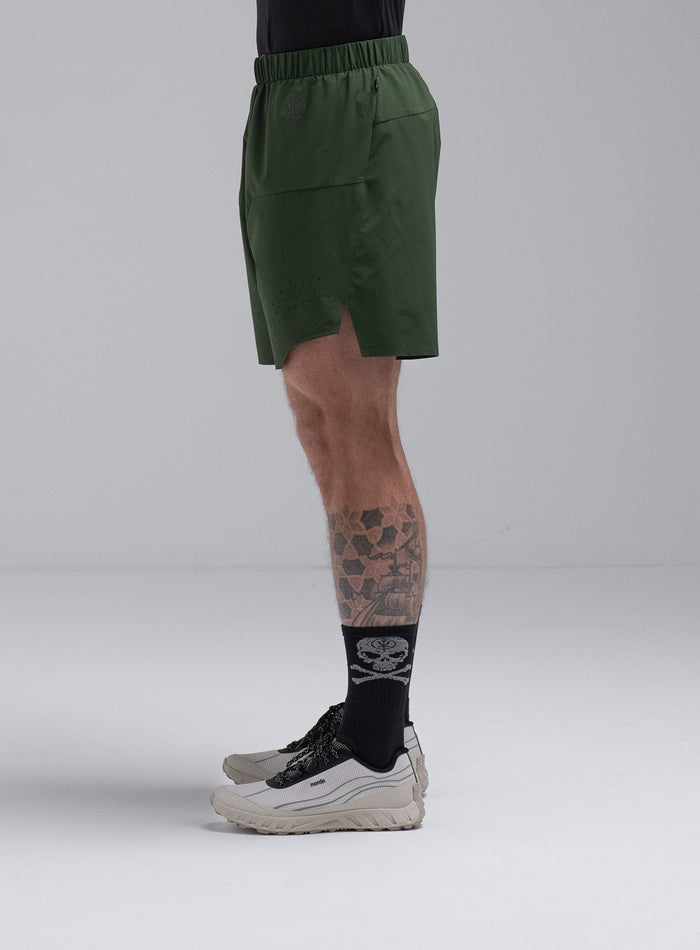 Chez Is 6ft And Wears Size: M | Hem Studio Image Of Model Wearing Force Trail Running 7" Shorts In Forest Green (SS Model)