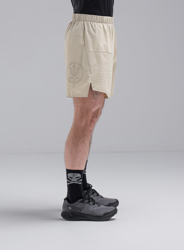 Chez Is 6ft And Wears Size: M | Hem Studio Image Of Model Wearing Force Trail Running 7" Shorts In Stone (SS Model)
