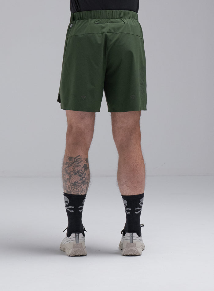 Chez Is 6ft And Wears Size: M | Hem Studio Image Of Model Wearing Force Trail Running 7" Shorts In Forest Green (SS Model)