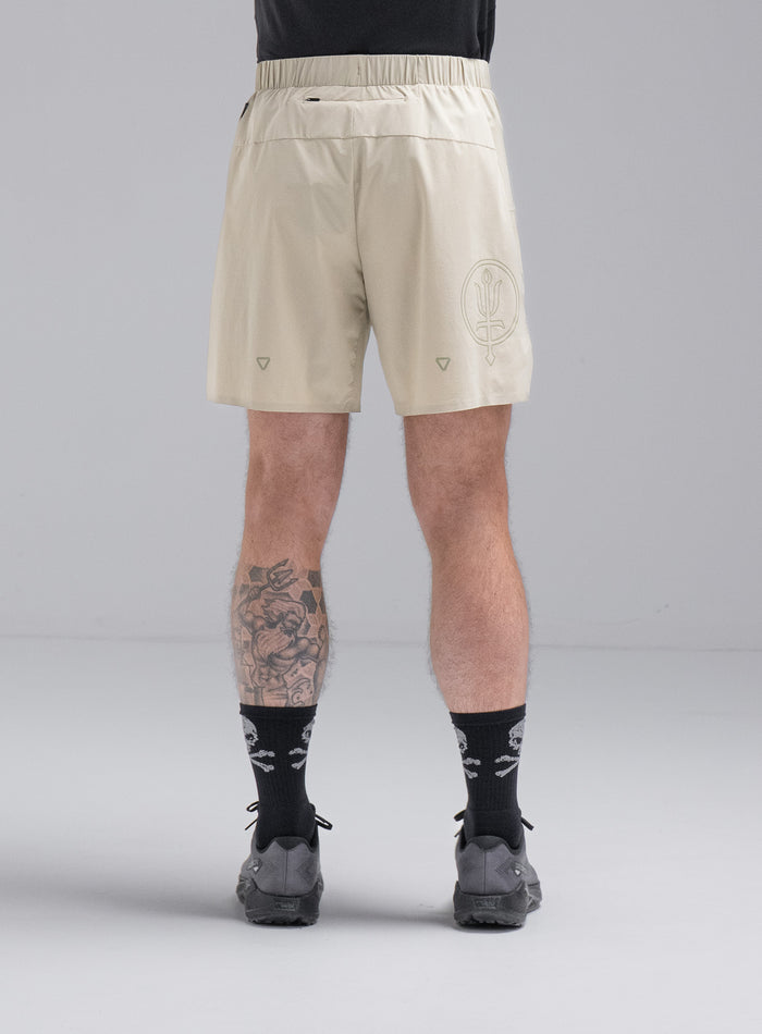 Chez Is 6ft And Wears Size: M | Hem Studio Image Of Model Wearing Force Trail Running 7" Shorts In Stone (SS Model)