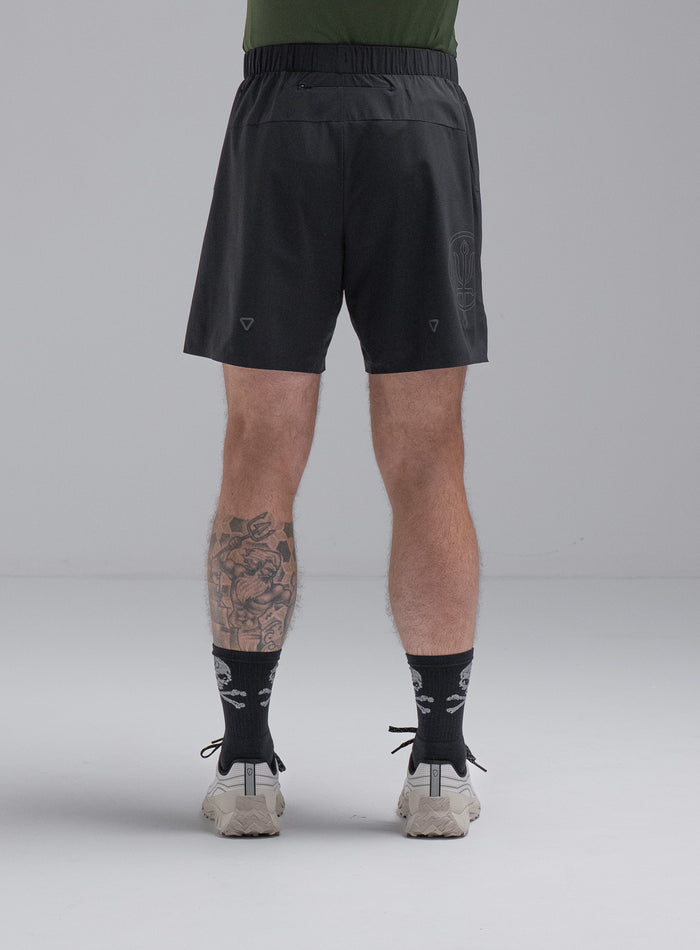 Chez Is 6ft And Wears Size: M | Hem Studio Image Of Model Wearing Force Trail Running 7" Shorts In Obsidian Black (SS Model)