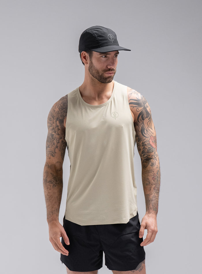 Chez Is 6ft And Wears Size: M | Hem Studio Image Of Model Wearing Force Trail Running Singlet In Stone (SS Model)