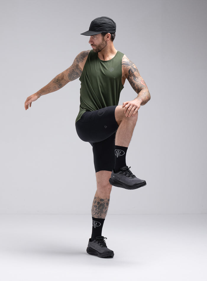 Chez Is 6ft And Wears Size: M | Hem Studio Image Of Model Wearing Force Trail Running Singlet In Forest Green (SS Model)