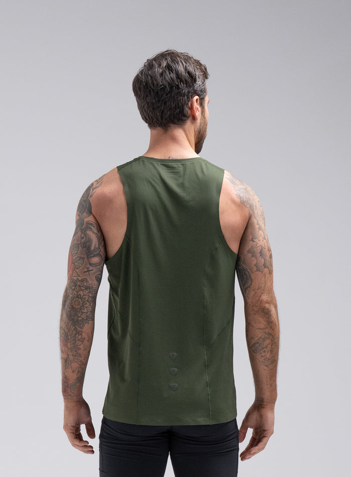 Chez Is 6ft And Wears Size: M | Hem Studio Image Of Model Wearing Force Trail Running Singlet In Forest Green (SS Model)