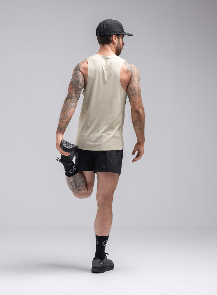 Chez Is 6ft And Wears Size: M | Hem Studio Image Of Model Wearing Force Trail Running Singlet In Stone (SS Model)