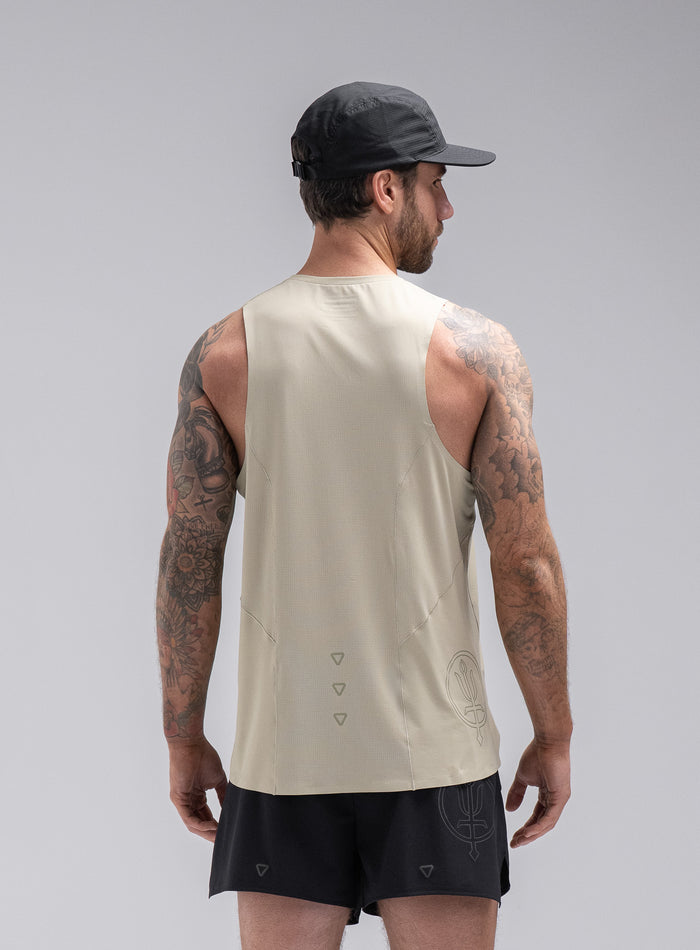 Chez Is 6ft And Wears Size: M | Hem Studio Image Of Model Wearing Force Trail Running Singlet In Stone (SS Model)