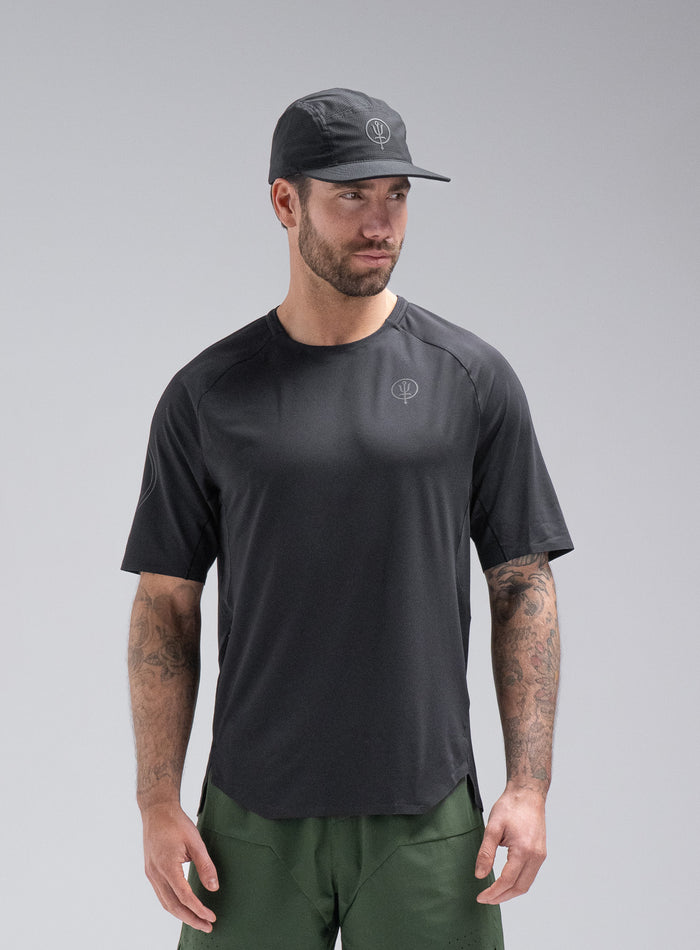 Chez Is 6ft And Wears Size: M | Hem Studio Image Of Model Wearing Force Trail Running T-Shirt In Obsidian Black (SS Model)
