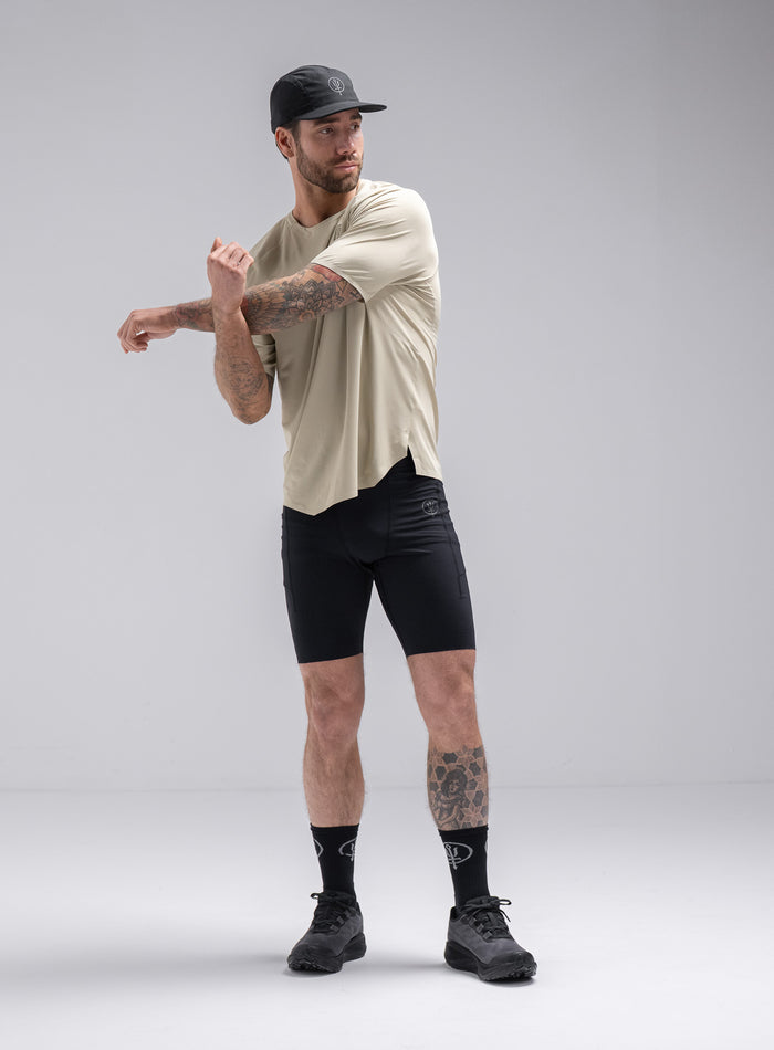 Chez Is 6ft And Wears Size: M | Hem Studio Image Of Model Wearing Force Trail Running T-Shirt In Stone (SS Model)