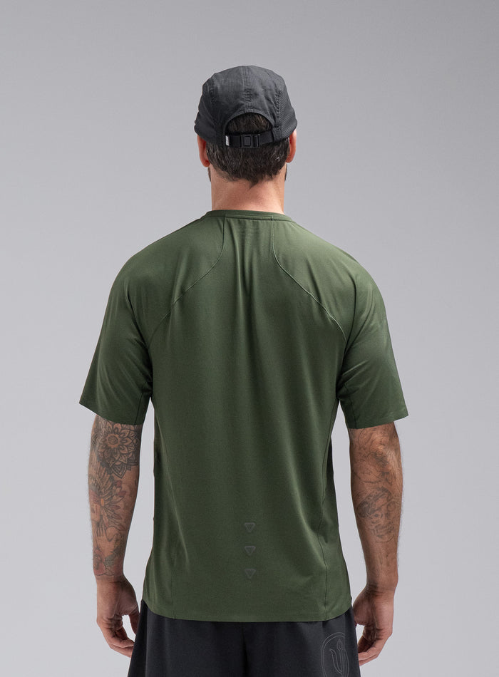 Chez Is 6ft And Wears Size: M | Hem Studio Image Of Model Wearing Force Trail Running T-Shirt In Forest Green (SS Model)