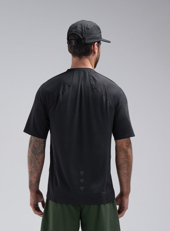 Chez Is 6ft And Wears Size: M | Hem Studio Image Of Model Wearing Force Trail Running T-Shirt In Obsidian Black (SS Model)