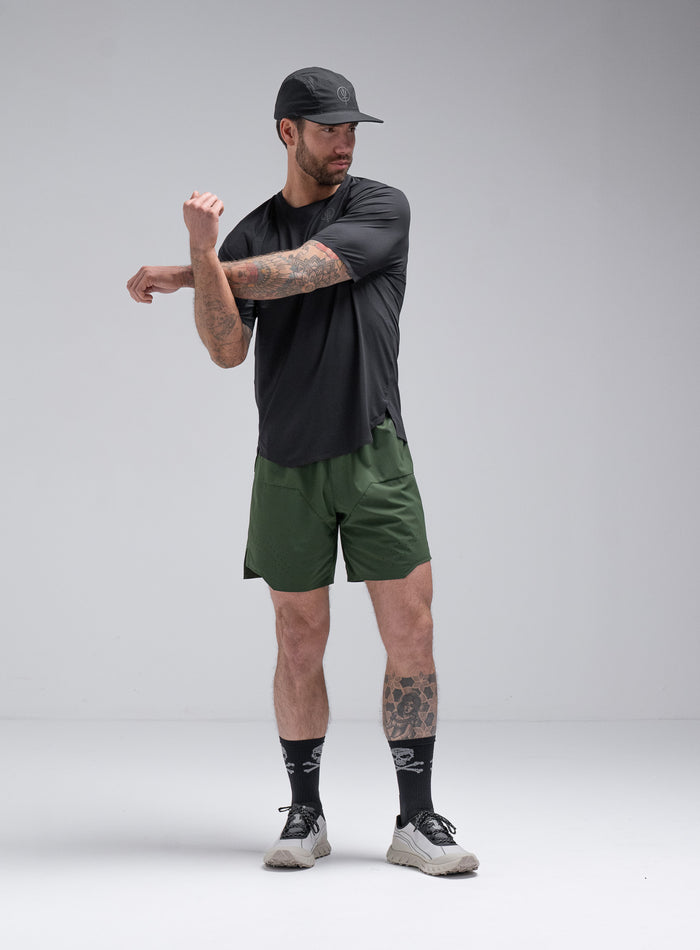 Chez Is 6ft And Wears Size: M | Hem Studio Image Of Model Wearing Force Trail Running T-Shirt In Obsidian Black (SS Model)