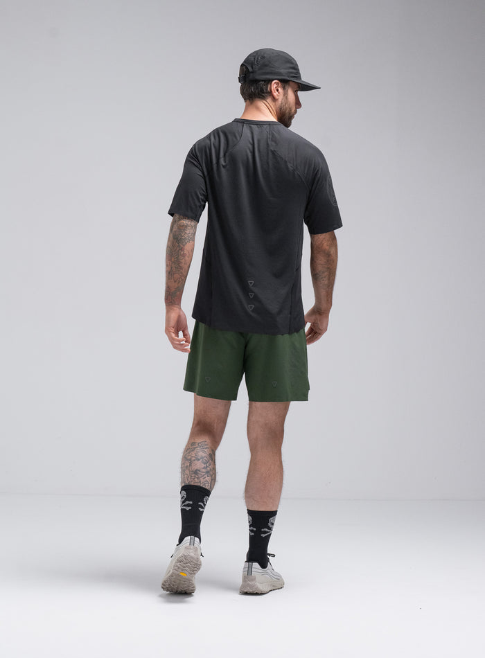 Chez Is 6ft And Wears Size: M | Hem Studio Image Of Model Wearing Force Trail Running T-Shirt In Obsidian Black (SS Model)