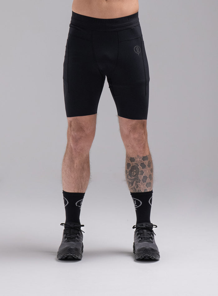 Chez Is 6ft And Wears Size: M | Hem Studio Image Of Model Wearing Force Trail Running Tight Shorts In Obsidian Black (SS Model)