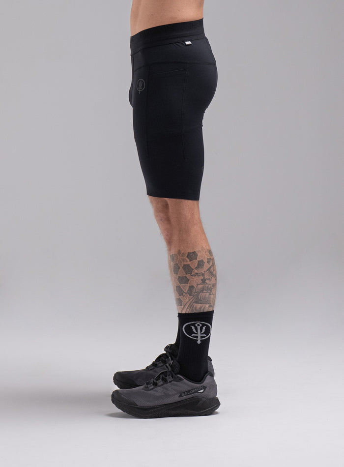 Chez Is 6ft And Wears Size: M | Hem Studio Image Of Model Wearing Force Trail Running Tight Shorts In Obsidian Black (SS Model)