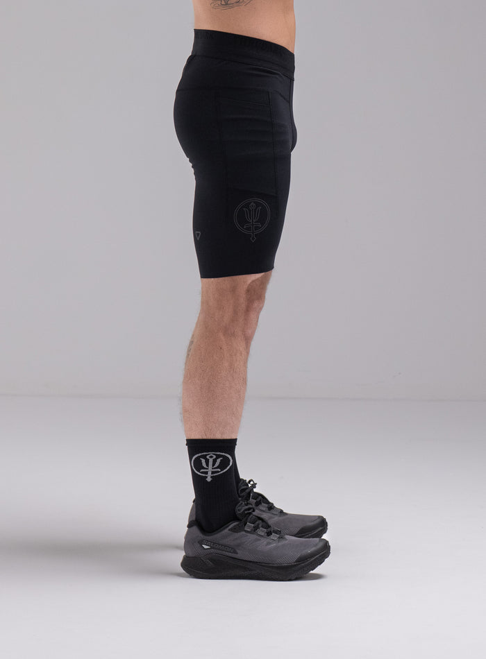 Chez Is 6ft And Wears Size: M | Hem Studio Image Of Model Wearing Force Trail Running Tight Shorts In Obsidian Black (SS Model)