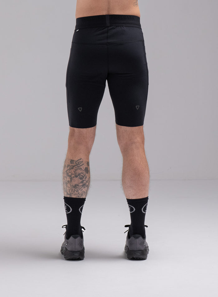 Chez Is 6ft And Wears Size: M | Hem Studio Image Of Model Wearing Force Trail Running Tight Shorts In Obsidian Black (SS Model)