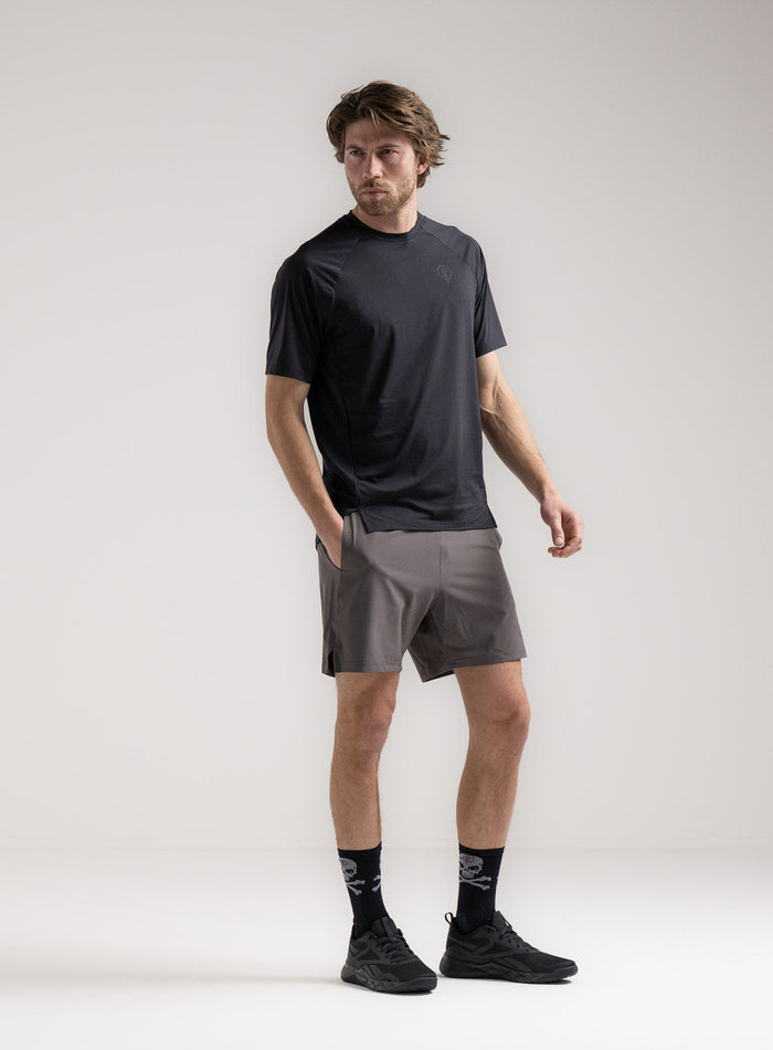 Rudie Is 6ft 2" And Wears Size: M | Hem Studio Image Of Model Wearing Force Velocity Motion T-Shirt In Obsidian Black (SS Model)