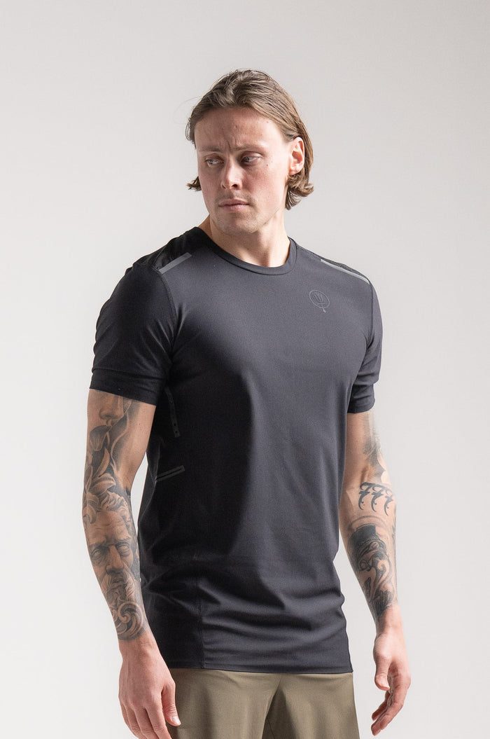 Angus Is 6ft 4" And Wears Size: L | Hem Studio Image Of Model Wearing Force Velocity Technical T-Shirt In Obsidian Black (SS Model)