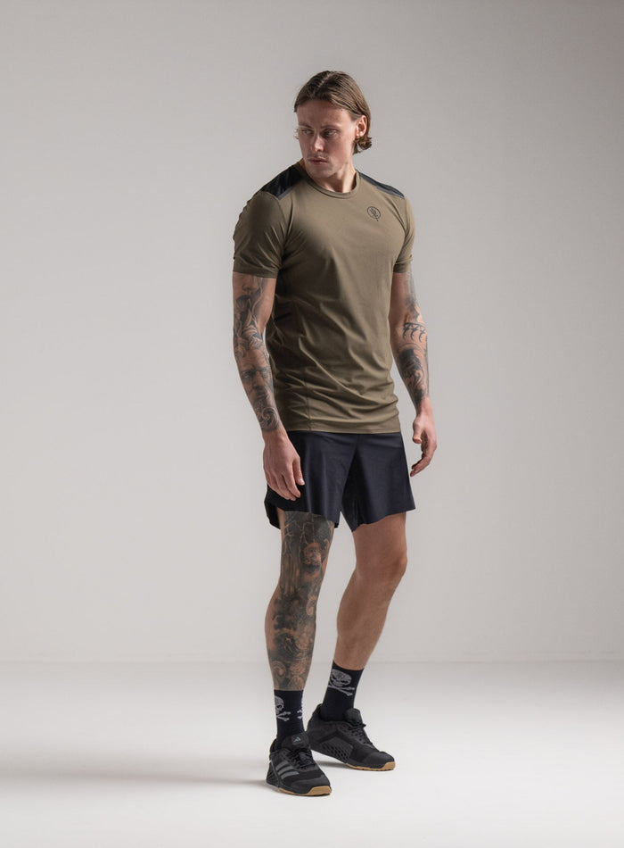 Angus Is 6ft 4" And Wears Size: L | Hem Studio Image Of Model Wearing Force Velocity Technical T-Shirt In Khaki (SS Model)