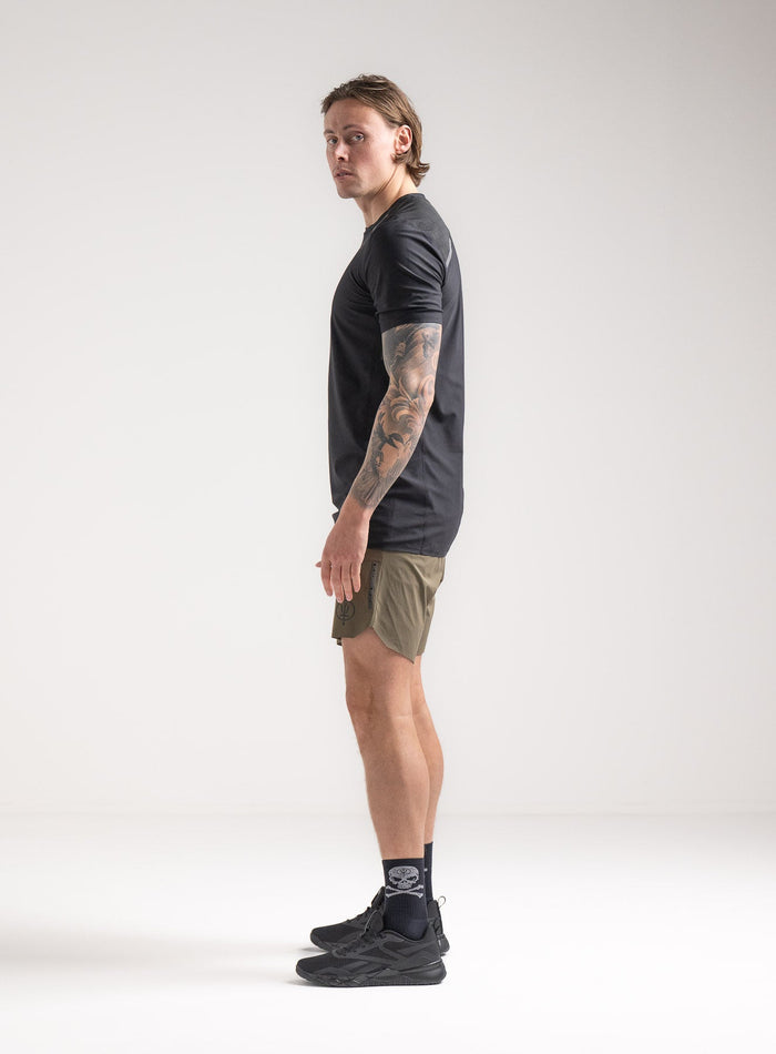 Angus Is 6ft 4" And Wears Size: L | Hem Studio Image Of Model Wearing Force Velocity Technical T-Shirt In Obsidian Black (SS Model)