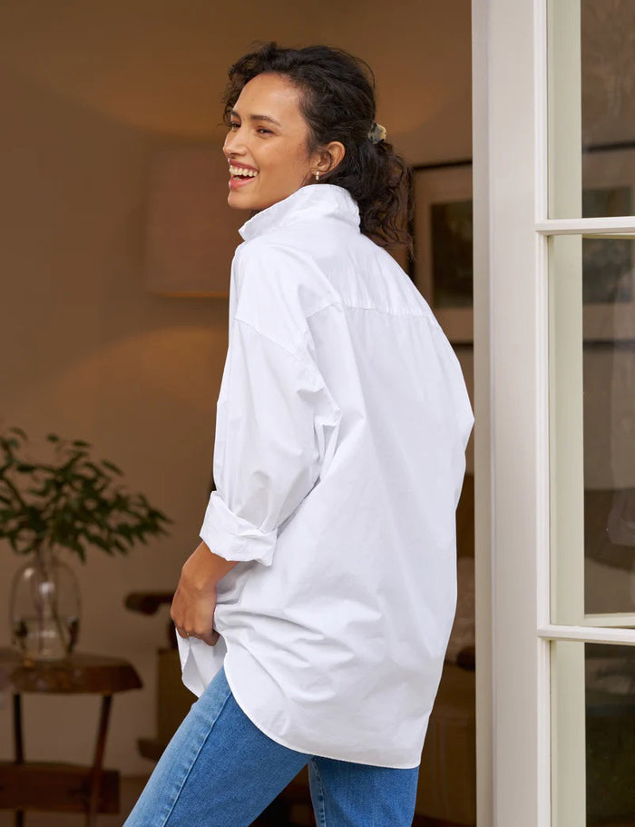 The FRANK AND EILEEN - SHIRLEY OVERSIZED BUTTON UP SHIRT features rolled long sleeves, a classic collar, a chest pocket, and an oversized fit. Made from 100% cotton poplin in classic white, the label inside is partially visible, making it ideal for casual wear.