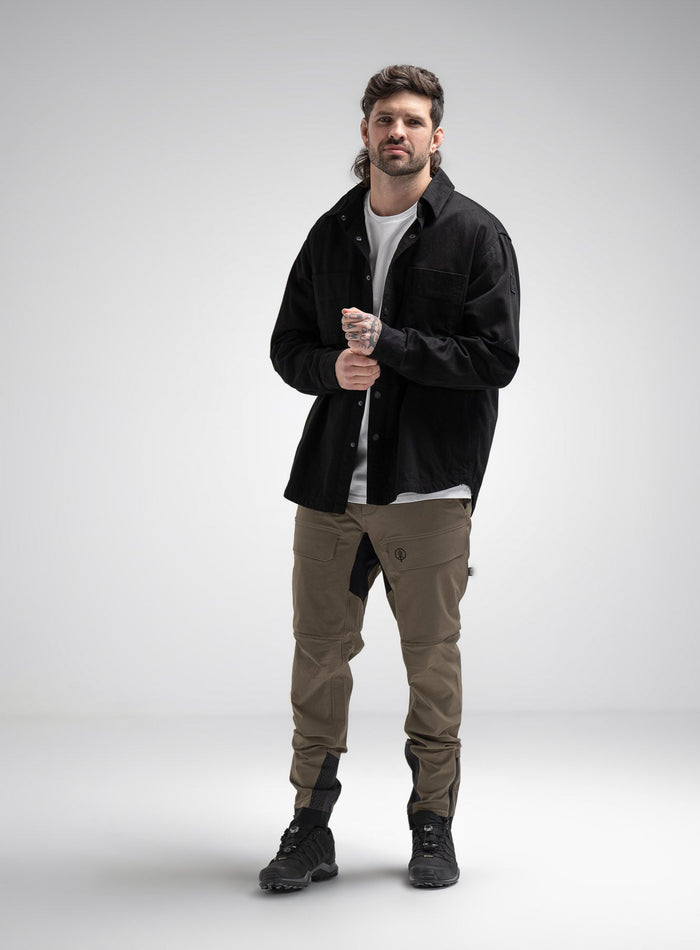 Bernie Is 6ft And Wears Size: M | Hem Studio Image Of Model Wearing Heavy Twill Overshirt In Black (SS Model)