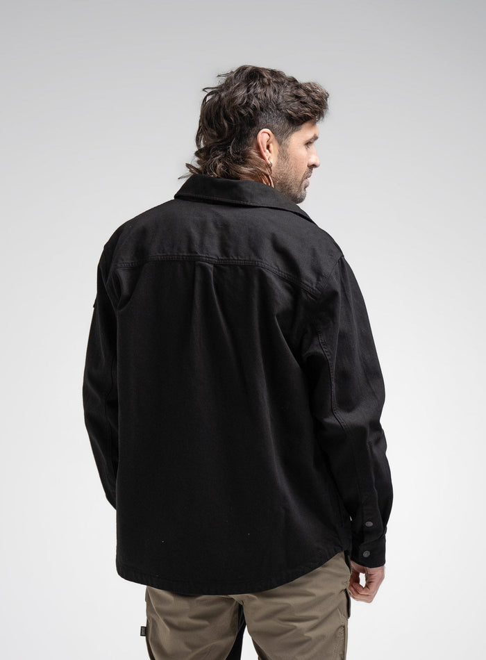 Bernie Is 6ft And Wears Size: M | Hem Studio Image Of Model Wearing Heavy Twill Overshirt In Black (SS Model)