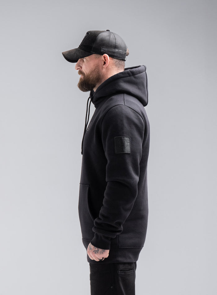 Staz Is 5ft 8" And Wears Size: S | Hem Studio Image Of Model Wearing Insignia Hoody - Thrudark X Scramble In Obsidian Black (SS Model)