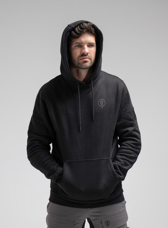 Bernie Is 6ft And Wears Size: M | Hem Studio Image Of Model Wearing Insignia Hoody In Obsidian Black (SS Model)