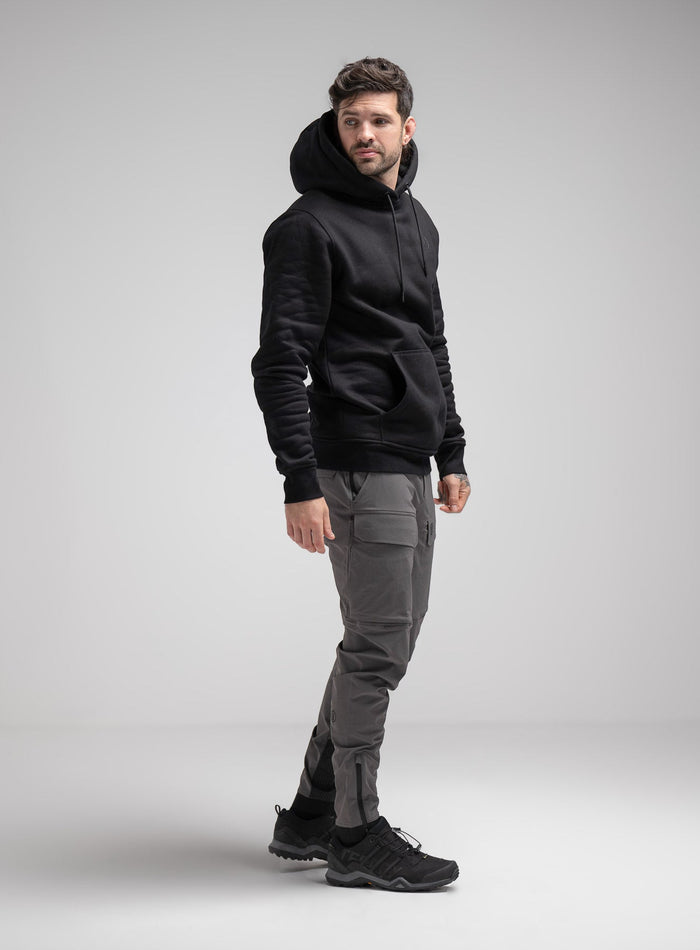 Bernie Is 6ft And Wears Size: M | Hem Studio Image Of Model Wearing Insignia Hoody In Obsidian Black (SS Model)