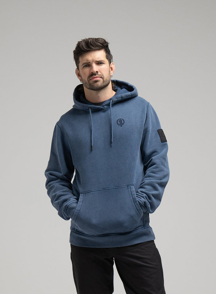 Bernie Is 6ft And Wears Size: M | Hem Studio Image Of Model Wearing Insignia Hoody Washed In Dark Sapphire (SS Model)