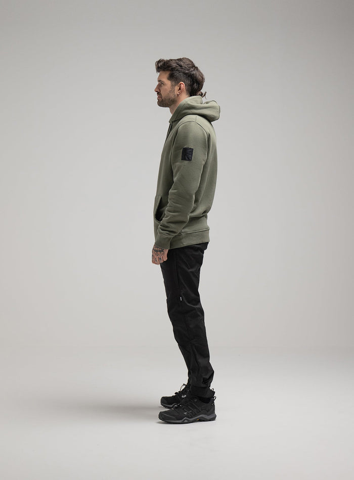 Bernie Is 6ft And Wears Size: M | Hem Studio Image Of Model Wearing Insignia Hoody Washed In Khaki (SS Model)