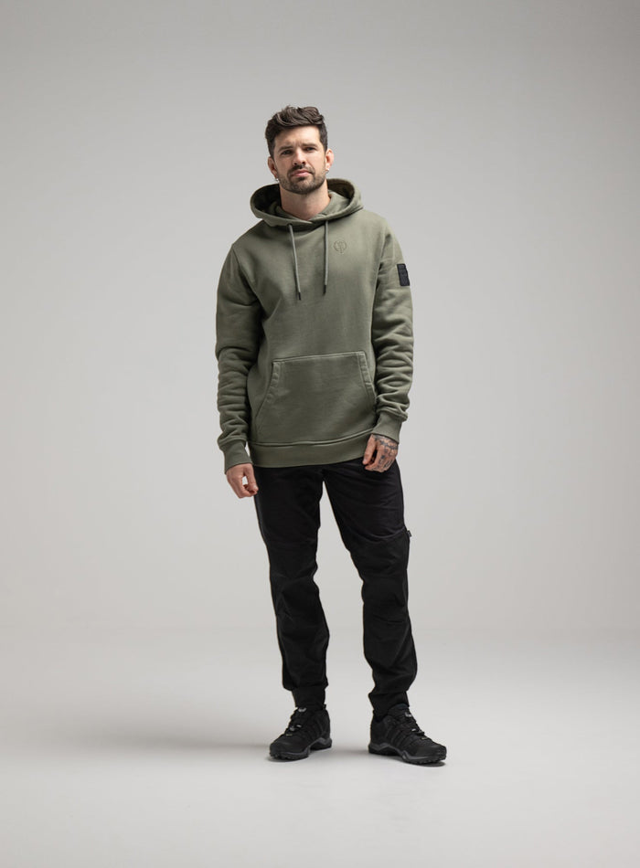 Bernie Is 6ft And Wears Size: M | Hem Studio Image Of Model Wearing Insignia Hoody Washed In Khaki (SS Model)