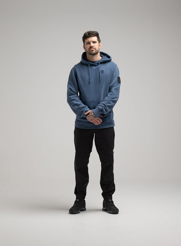 Bernie Is 6ft And Wears Size: M | Hem Studio Image Of Model Wearing Insignia Hoody Washed In Dark Sapphire (SS Model)