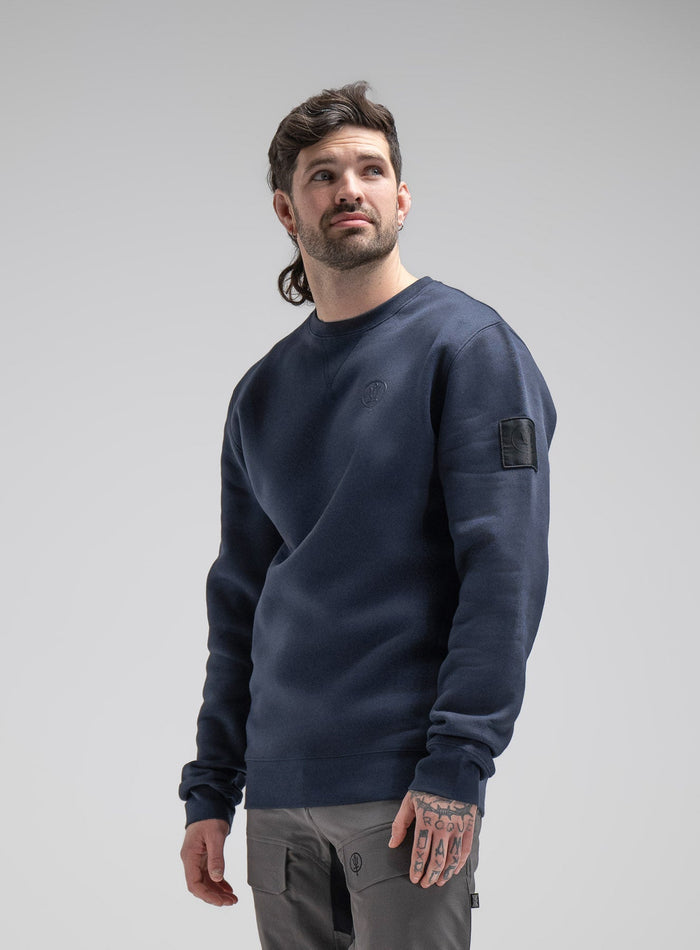 Bernie Is 6ft And Wears Size: M | Hem Studio Image Of Model Wearing Insignia Jumper In Dark Sapphire (SS Model)