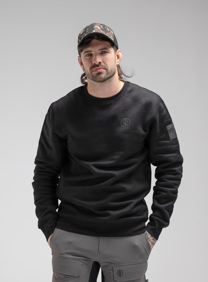 Bernie Is 6ft And Wears Size: M | Hem Studio Image Of Model Wearing Insignia Jumper In Obsidian Black (SS Model)