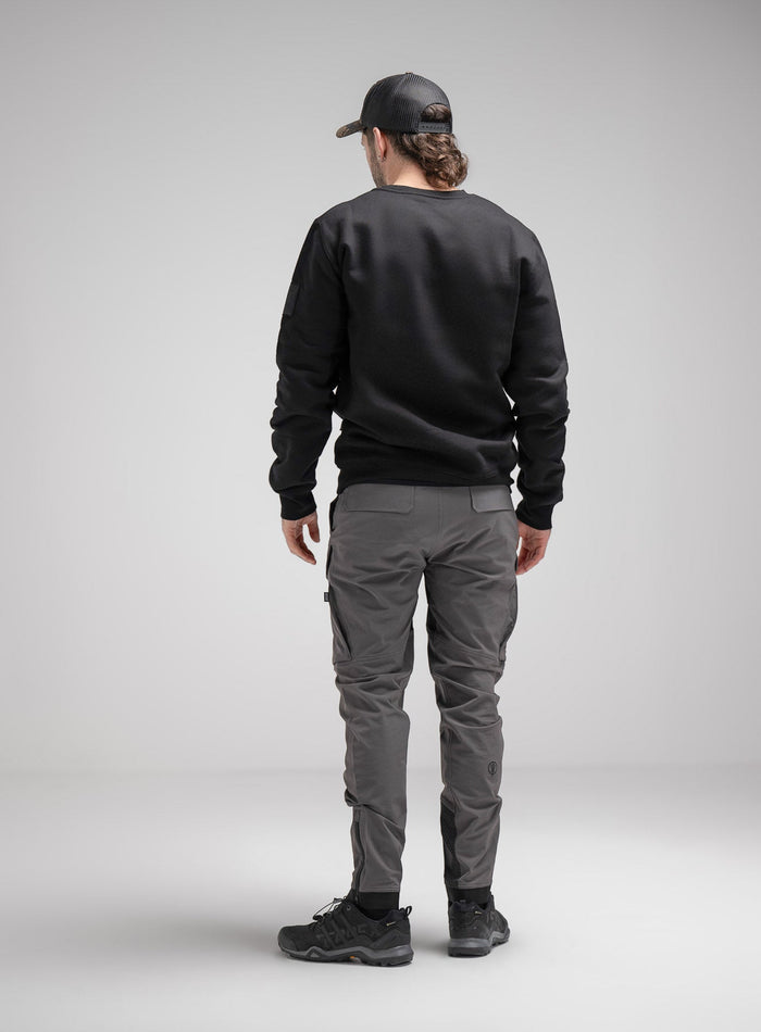 Bernie Is 6ft And Wears Size: M | Hem Studio Image Of Model Wearing Insignia Jumper In Obsidian Black (SS Model)
