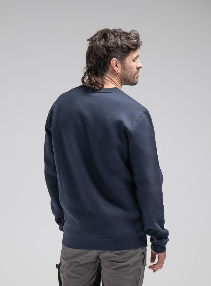 Bernie Is 6ft And Wears Size: M | Hem Studio Image Of Model Wearing Insignia Jumper In Dark Sapphire (SS Model)