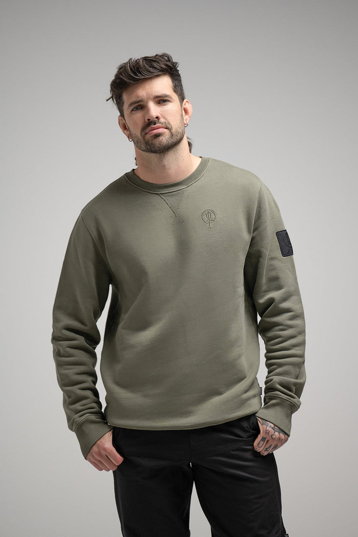 Bernie Is 6ft And Wears Size: M | Hem Studio Image Of Model Wearing Insignia Jumper Washed In Khaki (SS Model)