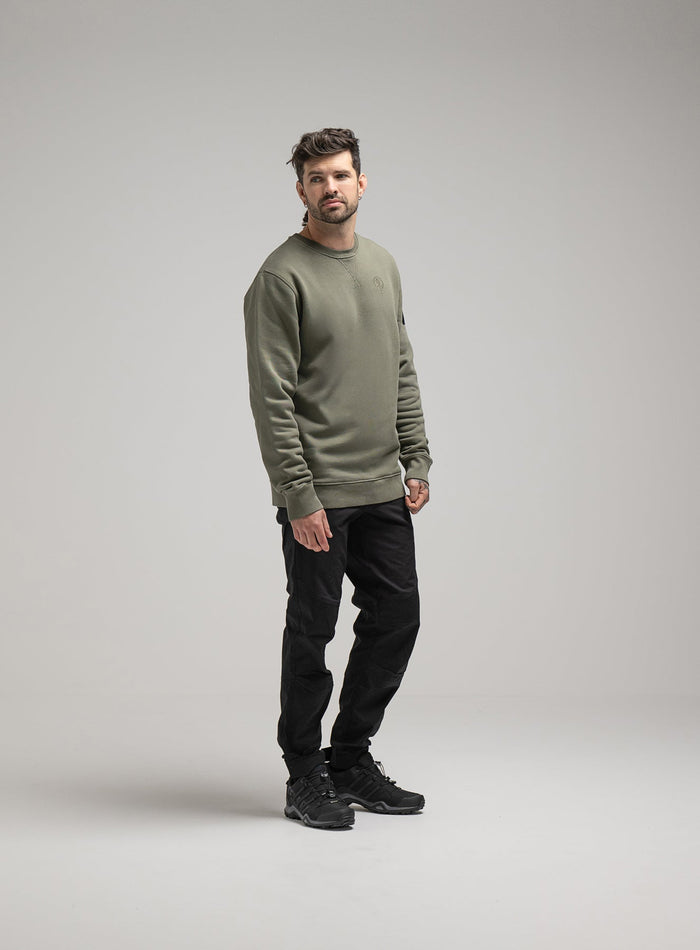 Bernie Is 6ft And Wears Size: M | Hem Studio Image Of Model Wearing Insignia Jumper Washed In Khaki (SS Model)