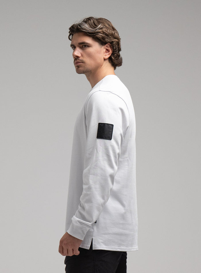 George Is 5ft 11" And Wears Size: S | Hem Studio Image Of Model Wearing Insignia Long Sleeve T-Shirt G1 In White (SS Model)