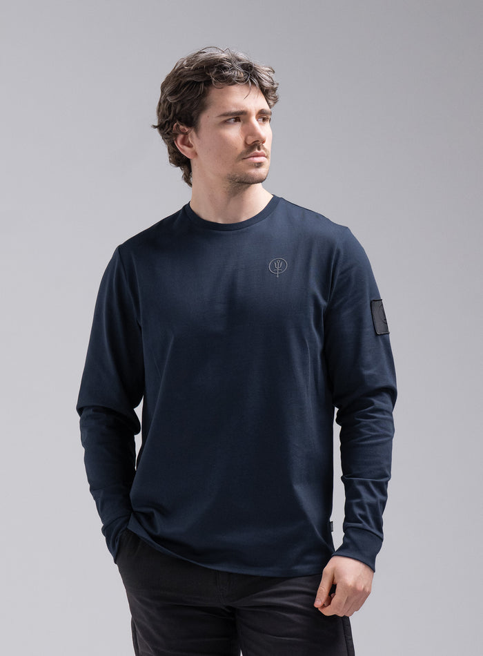 Jack Is 6ft 3" And Wears Size: L | Hem Studio Image Of Model Wearing Insignia Long Sleeve T-Shirt In Dark Sapphire (SS Model)