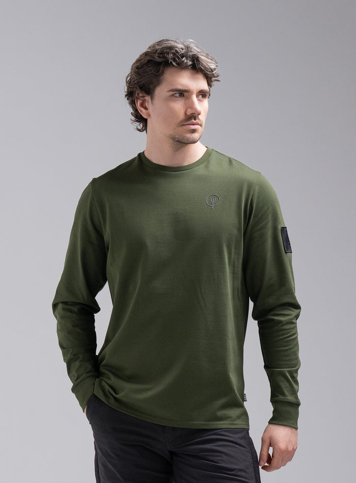 Jack Is 6ft 3" And Wears Size: L | Hem Studio Image Of Model Wearing Insignia Long Sleeve T-Shirt In Forest Green (SS Model)