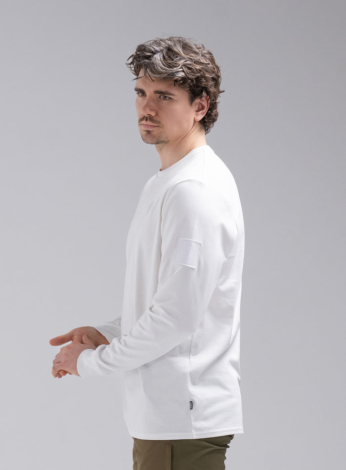 Jack Is 6ft 3" And Wears Size: L | Hem Studio Image Of Model Wearing Insignia Long Sleeve T-Shirt In Optic White (SS Model)