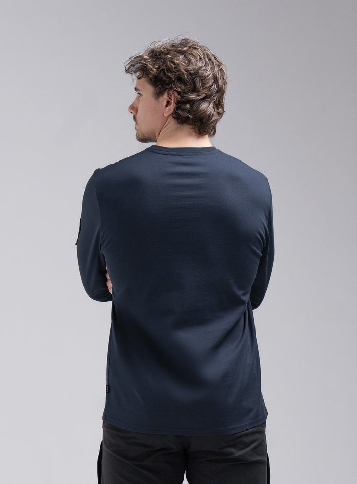 Jack Is 6ft 3" And Wears Size: L | Hem Studio Image Of Model Wearing Insignia Long Sleeve T-Shirt In Dark Sapphire (SS Model)